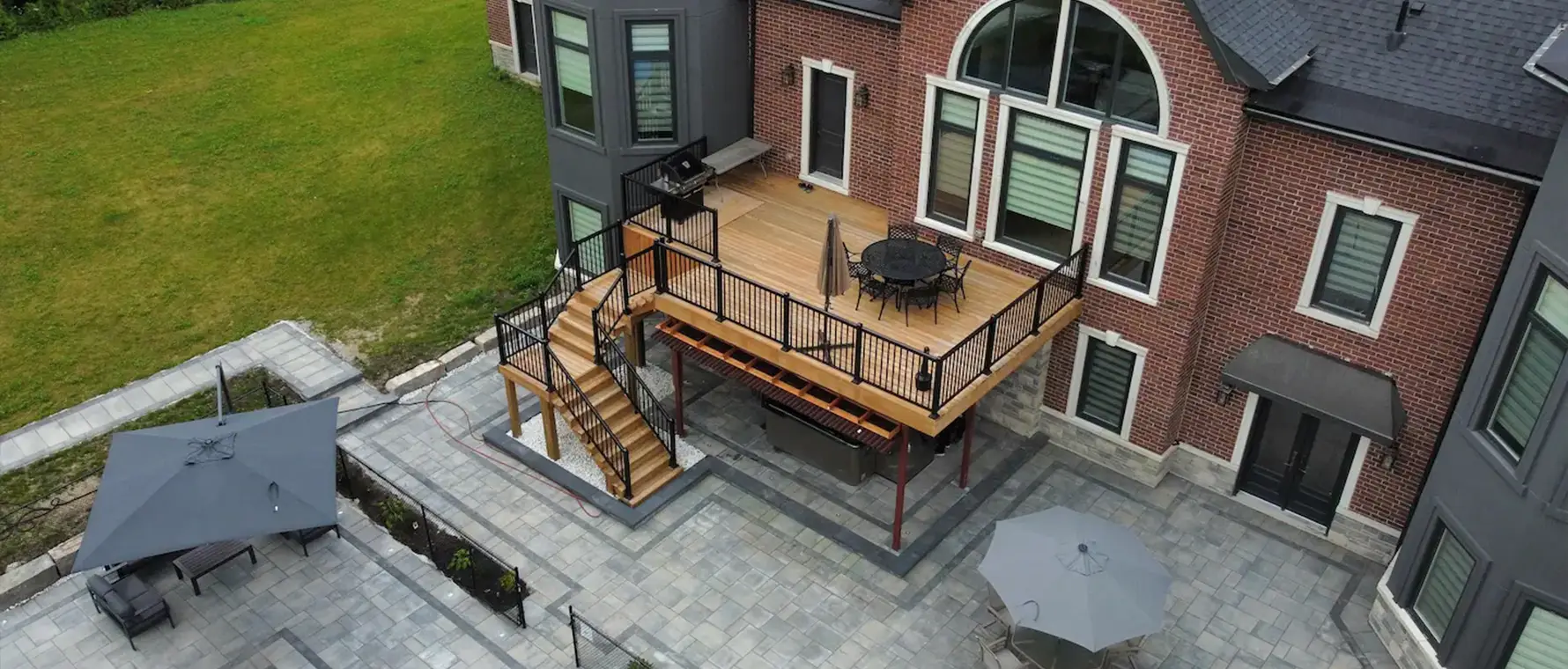 Aerial view of backyard fire pit area with interlock base and seating in Wasaga Beach