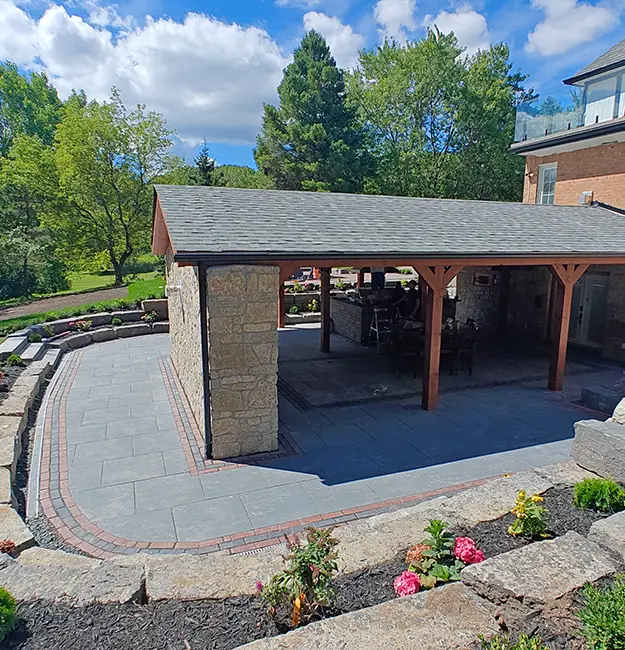 Covered outdoor living space with interlock pavers installed by hardscape installers in Aurora Ontario