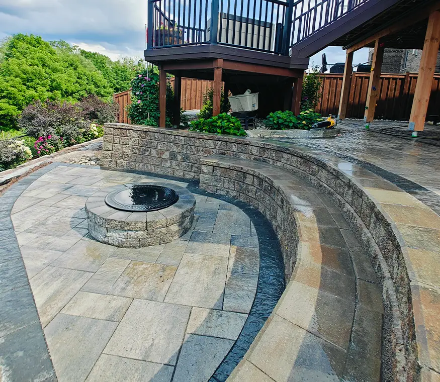 Curved interlock retaining wall and fire pit area in Kitchener Ontario