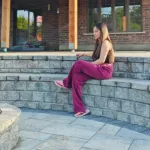 Curved interlock seating wall and patio installation in Kitchener Ontario beneath covered deck