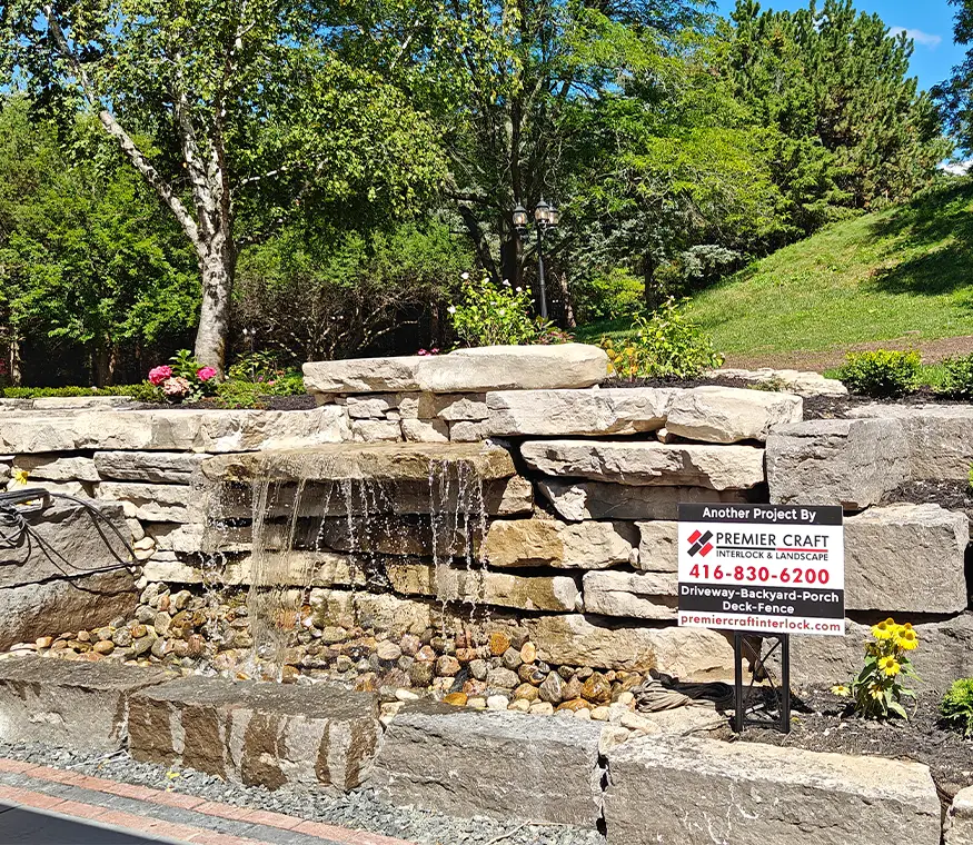 Custom covered pavilion with stone columns and interlock patio installed by hardscape contractors in Aurora Ontario