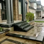 Flagstone front entrance and porch with custom stone steps built by professional hardscape contractor