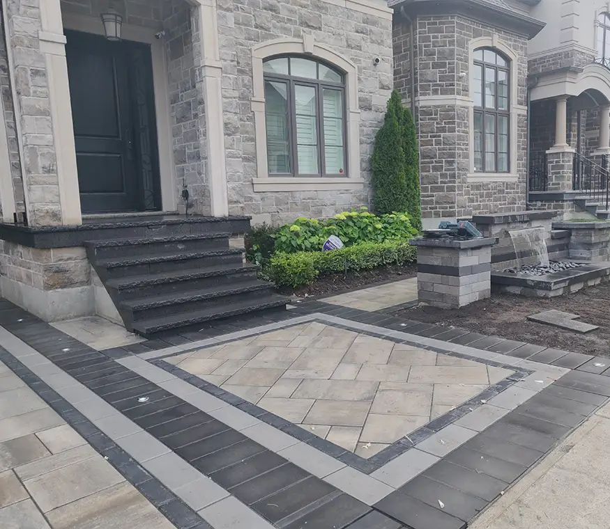 Front entrance landscape with stone walkway, steps, and planting beds