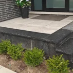 Front entrance stone porch and steps installation with modern hardscape design in Mississauga residential property