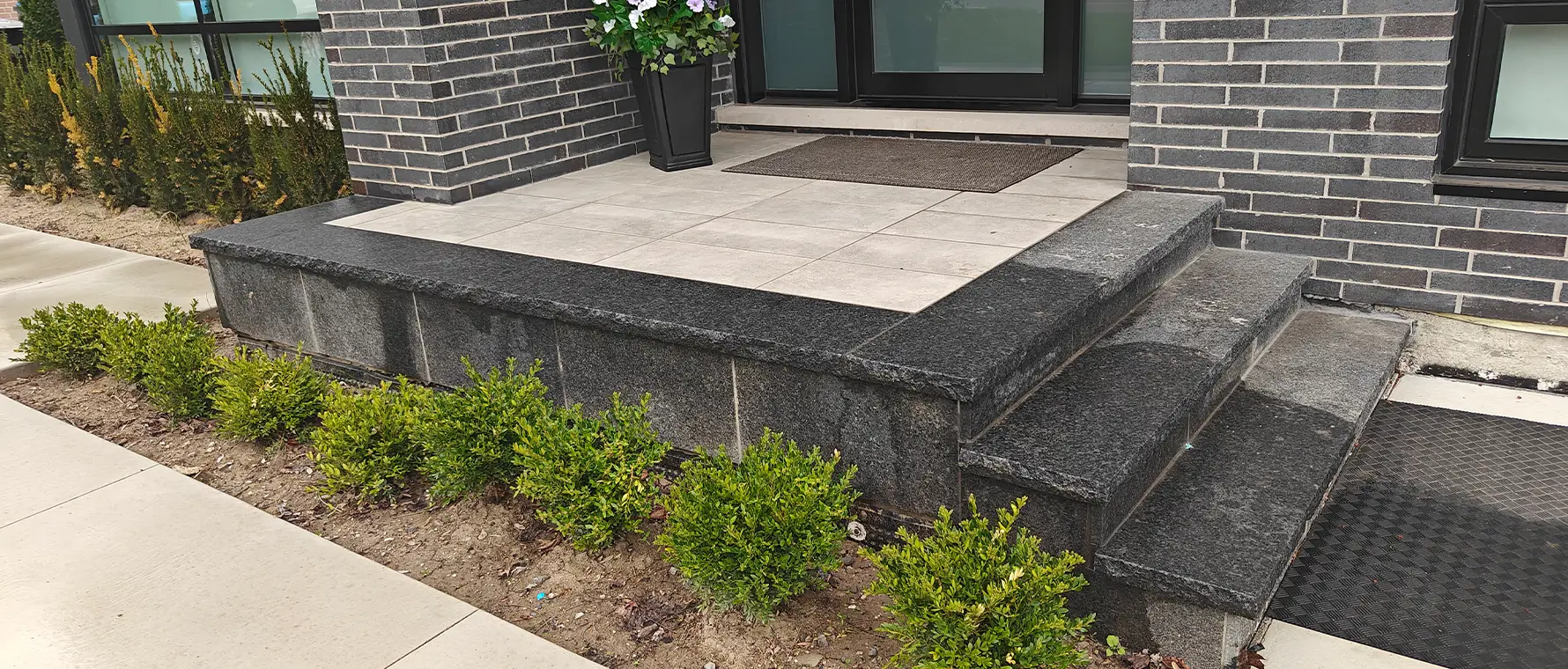 Front entrance stone porch and steps installation with modern hardscape design in Mississauga residential property
