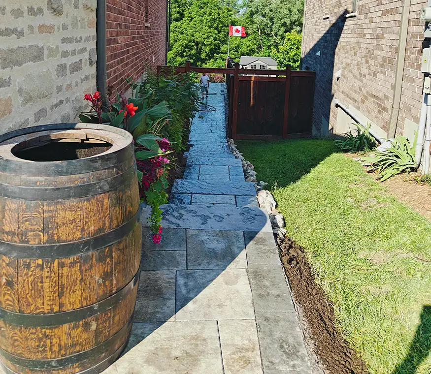 Front-to-back interlock pathway installation in Kitchener Ontario with garden edging