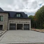 Front yard interlock driveway and stone edging under construction