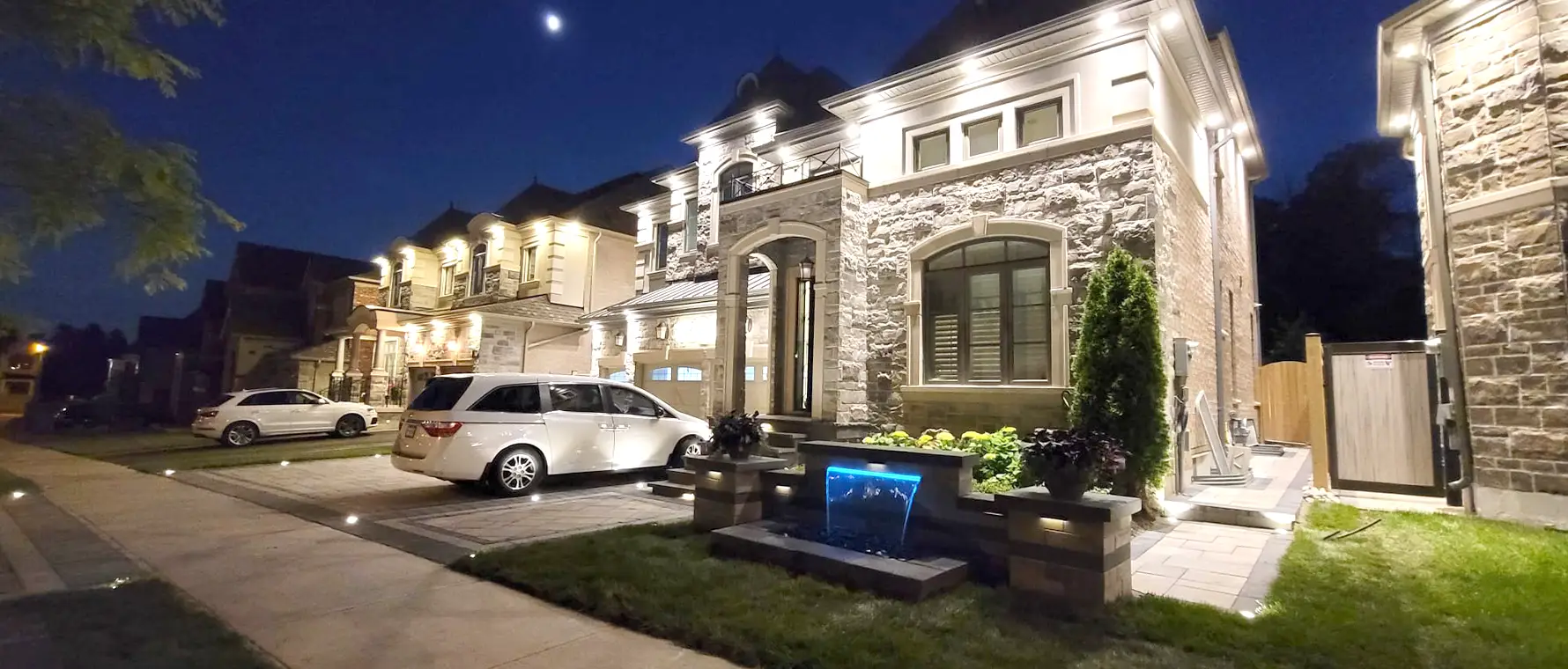 Front yard stone water feature with stacked stone and landscaping at Woodbridge home