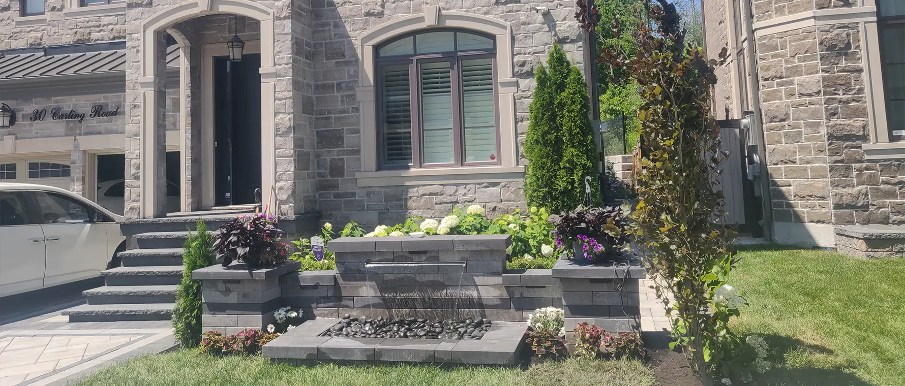 Front yard water feature with integrated LED lighting at night