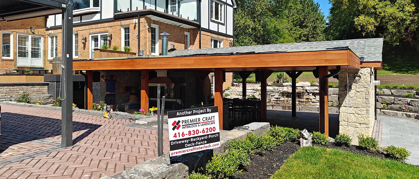 Herringbone interlock driveway installation in Aurora Ontario with curved stone borders by professional hardscape contractors