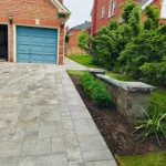 Interlock driveway with retaining wall and fresh landscaping in Richmond Hill