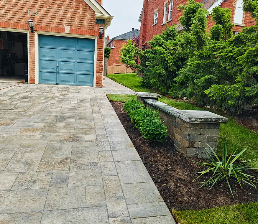 Interlock driveway with retaining wall and fresh landscaping in Richmond Hill