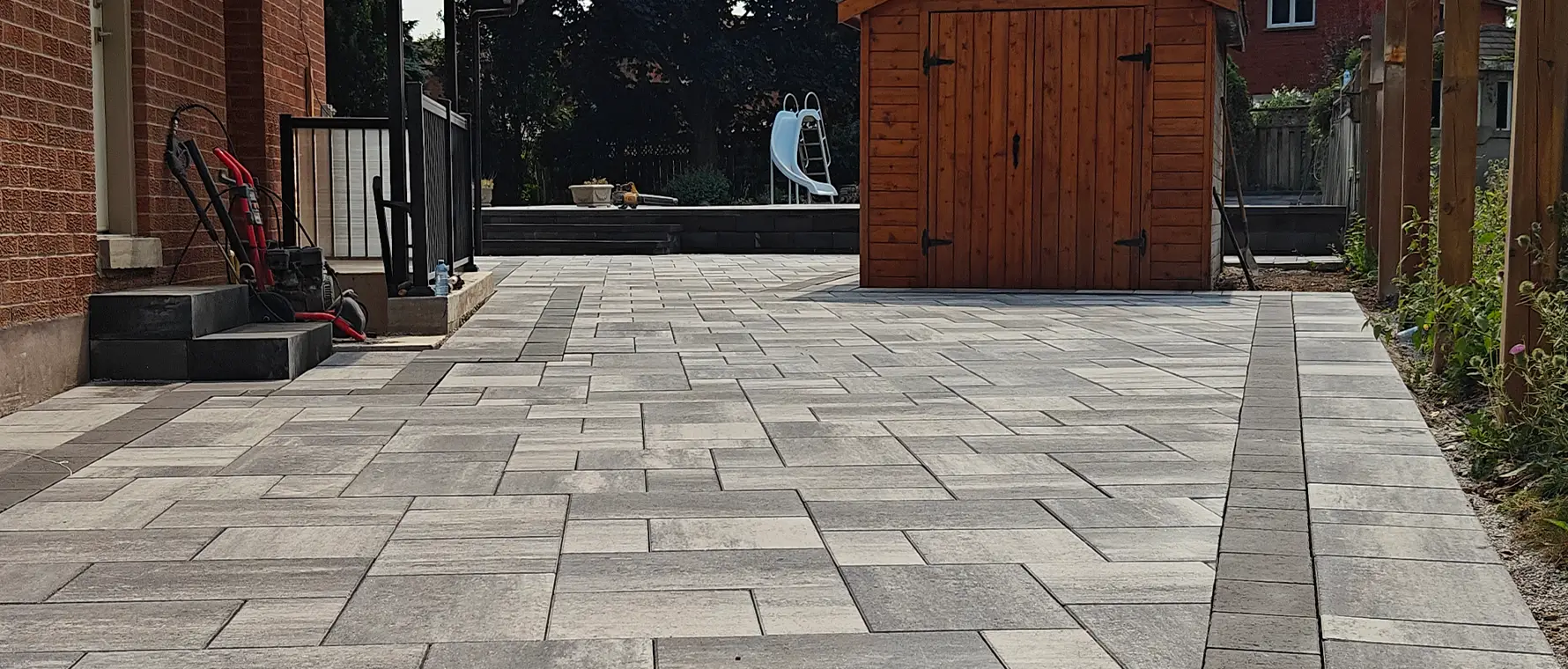 Interlock patio installation in progress around pool with new base preparation in Brampton Ontario