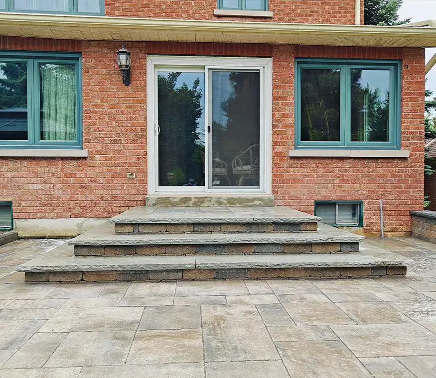 Interlock steps and landing leading to backyard entrance