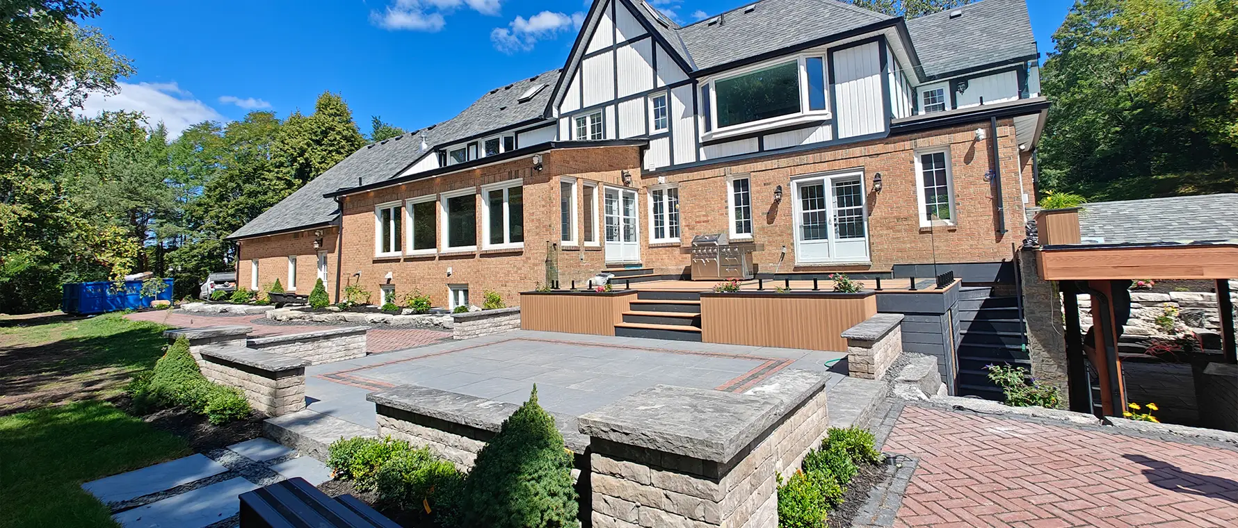 Natural stone retaining wall construction in progress by professional hardscape installers in Aurora Ontario