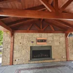 Natural stone retaining wall with built-in waterfall feature constructed by retaining wall contractors in Aurora Ontario