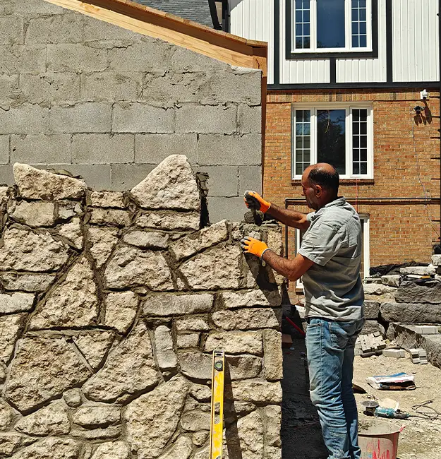 Outdoor kitchen installation within stone structure by skilled hardscape patio contractors in Aurora Ontario