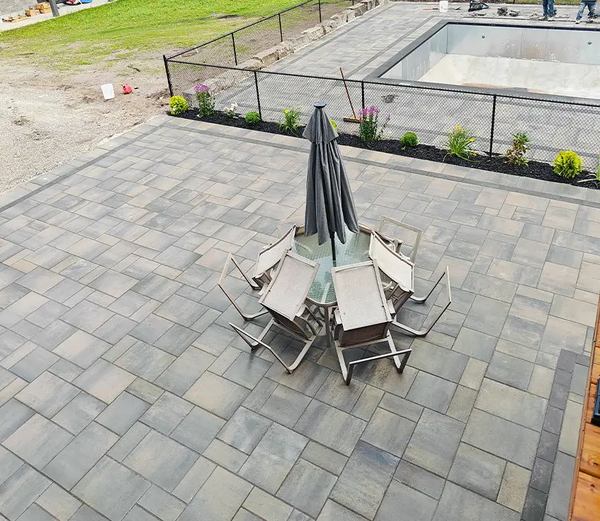Poolside interlock patio with seating area and fencing