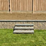 Retaining wall and stone steps installation by professional hardscape contractor at a residential property