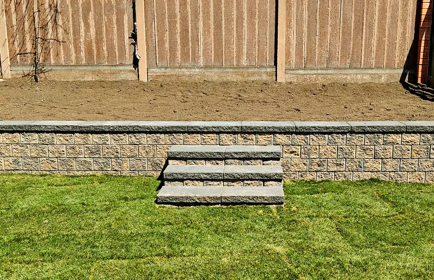 Retaining wall and stone steps installation by professional hardscape contractor at a residential property