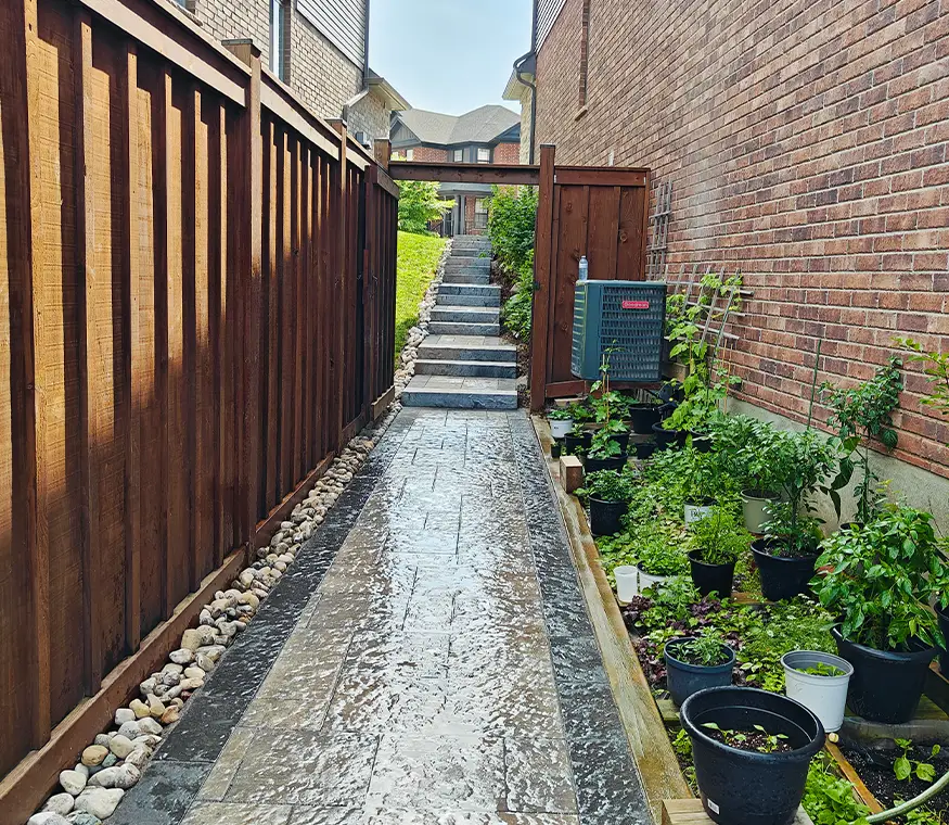 Side yard interlock walkway installation in Kitchener Ontario with clean border detailing
