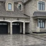 Stepping stone walkway with gravel base and planting beds beside house