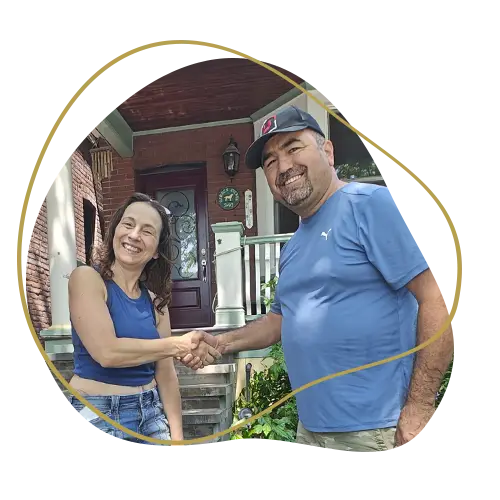 Landscaping contractor shaking hands with a satisfied homeowner after completing a backyard renovation