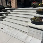 Manufactured stone porch installation by professional hardscape contractor