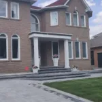 Manufactured stone porch installation with precise alignment