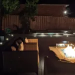 Natural Gas Fire Pit in Landscaped Backyard with Techo-Bloc Raffinato wall Stone